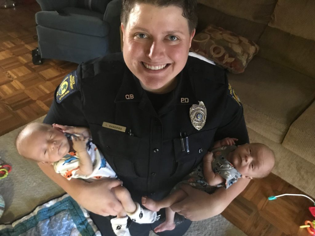 Contact 1 Ohana Foster care Founder Lauren in PD Uniform with Babies